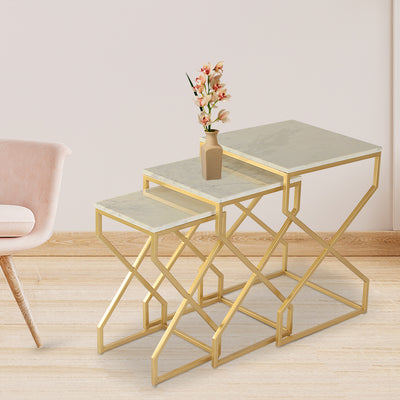 set of 3 nesting tables with white marble top and mild steel frame in gold finish having soft corners