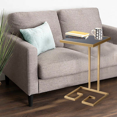 C shape side or end table with black glass top, supported by metal legs in gold finish