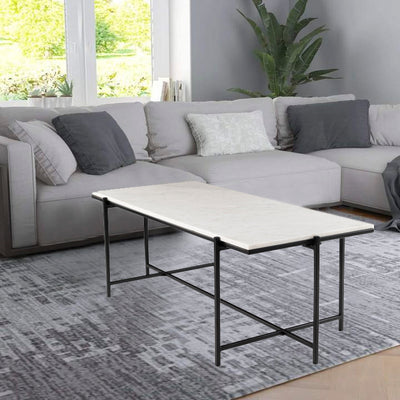 Rectangle coffee table with natural white marble top supported by metal legs in gold finish