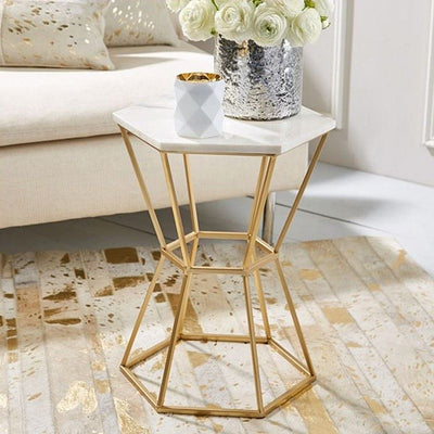 Hexagonal side or end table with marble top, supported by metal frame in gold finish