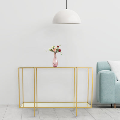 Glass console table contain two-tiered shelf top and bottom with mirror, supported by mild steel legs in gold finish