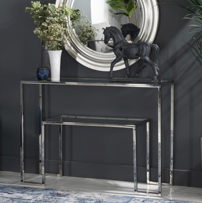 Rectangle console table with glass top supported by stainless steel legs in chrome finish