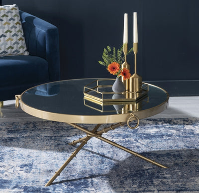 Round coffee table includes a mirror tabletop and metal legs in gold finish
