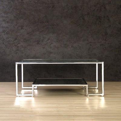 Rectangle coffee table with glass top supported by stainless steel legs in gold finish