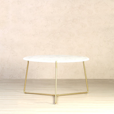 Round coffee table includes a white marble tabletop and metal legs in gold finish