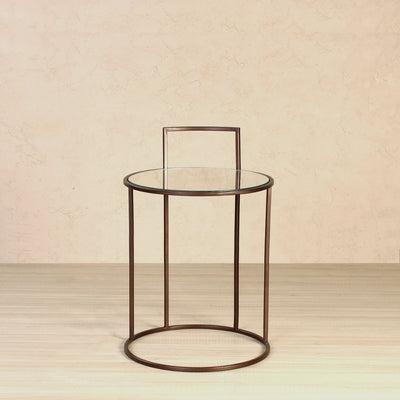 Round side or end table with glass top, supported by metal legs in bronze finish