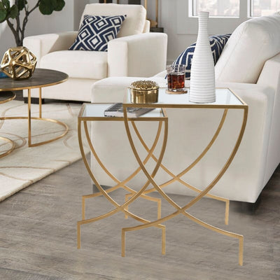 Set of 2 nesting tables with glass top and metal legs in gold finish